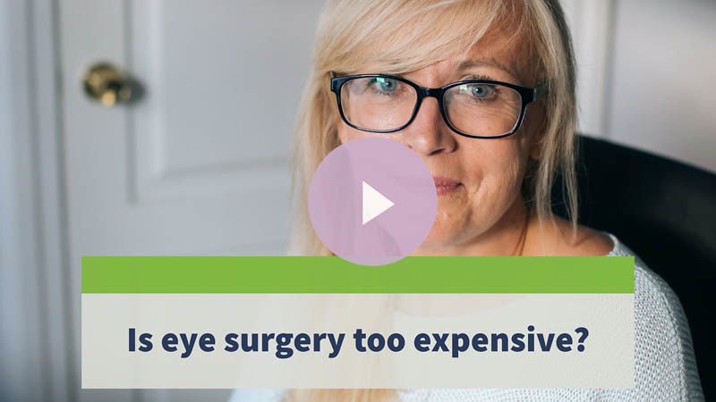 A senior woman with glasses looking at a camera.